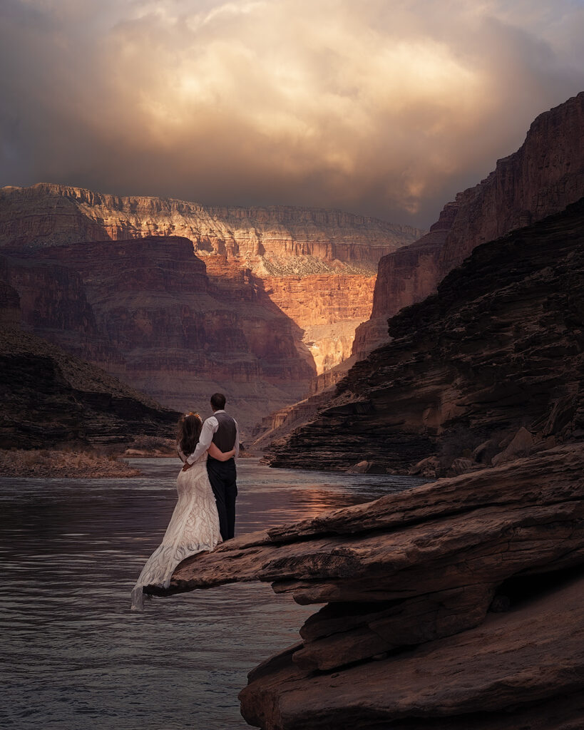 Natural Unions photograph of married couple standing on overhanging rock looking downstream on the Colorado River in Grand Canyon National Park